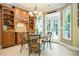 Dining room with a chandelier, built-in cabinets, seating and a view of the backyard at 725 Heathland Dr, Roswell, GA 30075