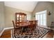 Elegant dining room with hardwood floors, a vaulted ceiling, and natural light from the shuttered windows at 725 Heathland Dr, Roswell, GA 30075