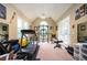 Bright exercise room with vaulted ceiling, multiple windows, and workout machines at 725 Heathland Dr, Roswell, GA 30075