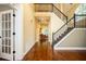 Inviting foyer with hardwood floors, a staircase with iron railings, and a view into a cozy living space at 725 Heathland Dr, Roswell, GA 30075