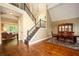 Grand foyer boasting hardwood floors, a staircase with iron railings, and an open view to the dining and living areas at 725 Heathland Dr, Roswell, GA 30075