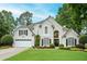 Charming traditional home featuring a manicured lawn, lush landscaping, and a welcoming two-car garage at 725 Heathland Dr, Roswell, GA 30075