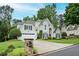 Lovely home with lush landscaping and a driveway leading to an attached garage, set on a beautifully maintained lawn at 725 Heathland Dr, Roswell, GA 30075