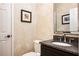 Cozy half bathroom features neutral wallpaper and a granite countertop sink at 725 Heathland Dr, Roswell, GA 30075