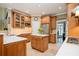 Traditional-style kitchen with tile floors, wood cabinets, stainless appliances, and a center island at 725 Heathland Dr, Roswell, GA 30075