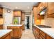Bright eat-in kitchen with wood cabinets, a center island, stainless appliances, and tile floors at 725 Heathland Dr, Roswell, GA 30075