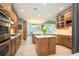 Spacious kitchen featuring an island, eat-in nook, stainless appliances, and wood cabinets at 725 Heathland Dr, Roswell, GA 30075