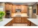 A modern kitchen featuring stainless appliances, wood cabinets, and a dual island setup at 725 Heathland Dr, Roswell, GA 30075