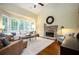 Bright living room with a fireplace, lots of natural light, and neutral decor at 725 Heathland Dr, Roswell, GA 30075
