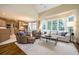 Large living room area with hardwood floors, an abundance of windows, and neutral-toned decor at 725 Heathland Dr, Roswell, GA 30075