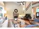 A spacious living room with a vaulted ceiling, fireplace, and hardwood flooring at 725 Heathland Dr, Roswell, GA 30075