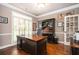Dedicated office space with hardwood floors, shuttered windows, and a built-in desk for productive work at 725 Heathland Dr, Roswell, GA 30075