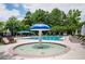 Community pool features lounge chairs, umbrellas, mushroom water feature, and mature shade trees at 725 Heathland Dr, Roswell, GA 30075