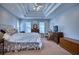 The spacious main bedroom offers neutral carpeting, large windows and a view of the wooded backyard at 9600 Poplar Ct, Douglasville, GA 30135