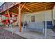 Covered patio space with a swing and kayaks, offering a unique outdoor storage solution at 9600 Poplar Ct, Douglasville, GA 30135
