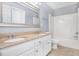 A well-lit bathroom featuring a double sink vanity with granite countertop and tub with shower at 2023 Arbor Springs Way, Buford, GA 30519