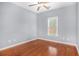 This bedroom offers warm hardwood flooring and natural light from a window at 2023 Arbor Springs Way, Buford, GA 30519
