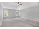 Spacious bedroom with soft carpet, tray ceiling and two large windows at 2023 Arbor Springs Way, Buford, GA 30519
