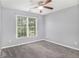 Cozy bedroom with carpet flooring, natural light from window and ceiling fan at 2023 Arbor Springs Way, Buford, GA 30519