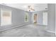 A bright bedroom with neutral carpet, ceiling fan and access to an ensuite bathroom at 2023 Arbor Springs Way, Buford, GA 30519