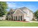Side view of a two-story brick home with attached two-car garage at 2023 Arbor Springs Way, Buford, GA 30519