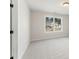 Bright bedroom with plush carpet, a window providing a view of the neighborhood, and white trim at 2719 Byess Ct, Marietta, GA 30064