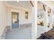 Covered front porch with brick base and gray front door at 2719 Byess Ct, Marietta, GA 30064