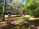 Spacious backyard with terraced retaining wall and mature trees at 5618 Highway 212, Covington, GA 30016