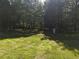 Expansive backyard featuring a lush lawn and dense trees providing privacy at 5618 Highway 212, Covington, GA 30016