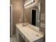 Bathroom featuring double sink vanity, large mirror, and white cabinets at 5618 Highway 212, Covington, GA 30016