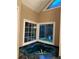 Bathroom with tub and large corner windows at 5618 Highway 212, Covington, GA 30016
