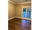 Bedroom with hardwood floors, neutral walls, white trim and large windows with natural light at 5618 Highway 212, Covington, GA 30016