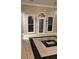 Elegant dining area featuring decorative tiled floors, chandelier, and natural light at 5618 Highway 212, Covington, GA 30016