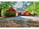 Charming red brick home with lush green trees surrounding the property at 5618 Highway 212, Covington, GA 30016