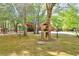 View of front yard with mature trees, well maintained yard, and building site at 5618 Highway 212, Covington, GA 30016