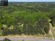 Aerial view of the property outline surrounded by lush trees and conveniently located along a paved road at 5618 Highway 212, Covington, GA 30016