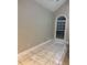 Neutral-toned room with a large window, tiled flooring, and vaulted ceiling at 5618 Highway 212, Covington, GA 30016