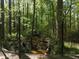 A serene stream flows through a wooded area with mature trees at 5618 Highway 212, Covington, GA 30016