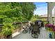 Outdoor back deck features a patio table, chairs, grill, and view of the private backyard at 1645 Horseshoe Creek Ln, Cumming, GA 30041