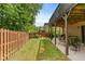 Backyard featuring a well-maintained lawn, a wooden fence, patio, and plenty of green foliage at 1645 Horseshoe Creek Ln, Cumming, GA 30041