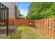 Backyard featuring a well-maintained lawn, a wooden fence and plenty of green foliage at 1645 Horseshoe Creek Ln, Cumming, GA 30041