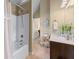 Bathroom with shower-tub combination and dark vanity at 1645 Horseshoe Creek Ln, Cumming, GA 30041