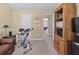 Bedroom with tan walls, with a bookcase and stationary bike at 1645 Horseshoe Creek Ln, Cumming, GA 30041