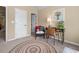 A cozy bedroom features a patterned rug, decorative chair, and stylish desk at 1645 Horseshoe Creek Ln, Cumming, GA 30041