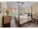 A lovely bedroom features a four-poster bed, a large window, and ample natural light at 1645 Horseshoe Creek Ln, Cumming, GA 30041