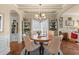 Inviting dining room with coffered ceiling, hardwood floors, and stylish furnishings adjacent to a sunlit living space at 1645 Horseshoe Creek Ln, Cumming, GA 30041