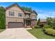 Charming two-story home featuring manicured lawn, two-car garage, and decorative shutters, complete with beautiful landscaping at 1645 Horseshoe Creek Ln, Cumming, GA 30041