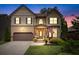 Charming two-story home featuring manicured lawn, two-car garage, and decorative shutters, complete with beautiful landscaping at 1645 Horseshoe Creek Ln, Cumming, GA 30041