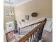 Bright, two-story foyer with elegant chandelier, hardwood floors, and staircase with wrought iron railings at 1645 Horseshoe Creek Ln, Cumming, GA 30041