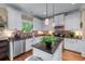 Modern kitchen with stainless appliances, granite counters, white cabinets, tile backsplash, and hardwood floors at 1645 Horseshoe Creek Ln, Cumming, GA 30041